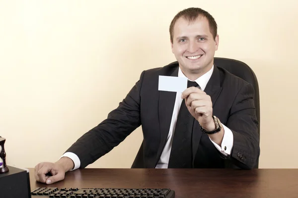 Business man showing a business card — стоковое фото