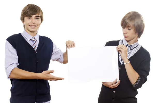 Двоє молодих хлопців тримають порожній аркуш / білий плакат — стокове фото