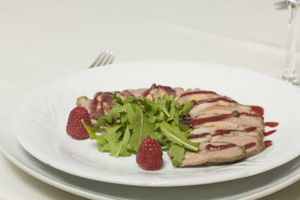 Cutting of pork with raspberry sauce — Stock Photo, Image