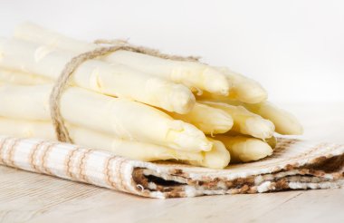 White asparagus on wooden table clipart