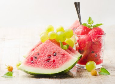 Slices of watermelon on wooden table clipart