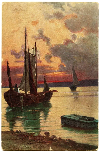 Seascape with two boats sailing against the sunset sky