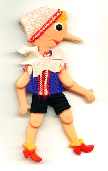 Antique toy Pinocchio puppet with a long nose — Stock Photo, Image