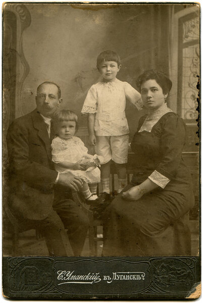 RUSSIA - CIRCA end of the XIX - the beginning of XX century: An antique photo shows family with two children, Lugansk, Russian Empire Russian text: Umanskiy (name of photographer), Lugansk