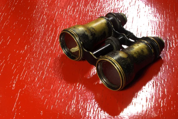 Vintage binoculars isolated on red background — Stock Photo, Image