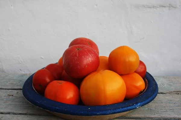 stock image Fresh tomatos on a blue plate