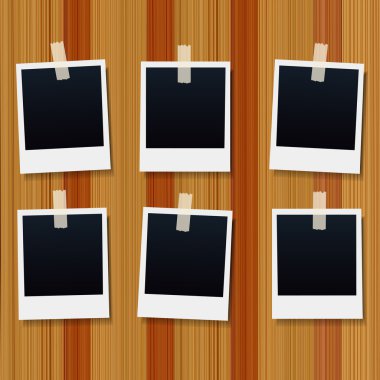 Photo frames on wood background clipart