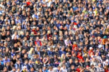 Blurred crowd of spectators on a stadium tribune clipart