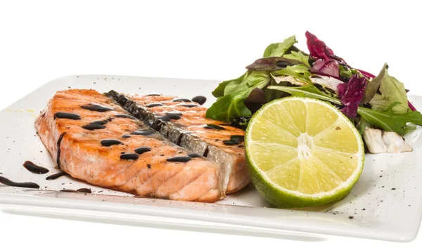 stock image Savory fish portion : roasted norwegian salmon fillet garnished