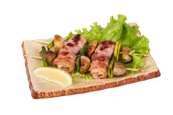 Bacon wrapped grilled Scallops with mushrooms and bacon Stock Image