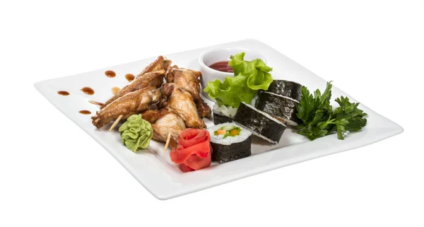 stock image Buffalo chicken wings on plate with sushi