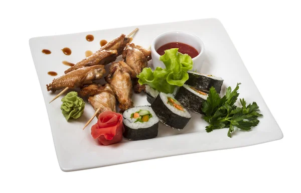 stock image Buffalo chicken wings on plate with sushi