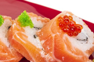 Japanese sushi traditional japanese food.Roll made of salmon, red cavair, roe and cream clipart