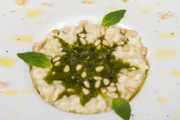 Photo of delicious risotto dish with herbs and cedar nut on white background — Stock Photo, Image