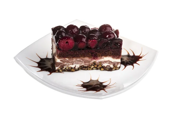 Chocolate cake with cherry on top on a white background — Stock Photo, Image