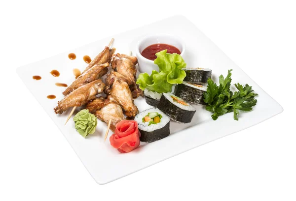 stock image Buffalo chicken wings on plate with sushi