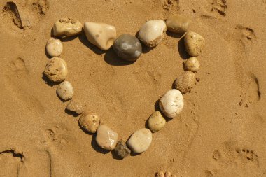 Love heart from pebbles on a beach clipart