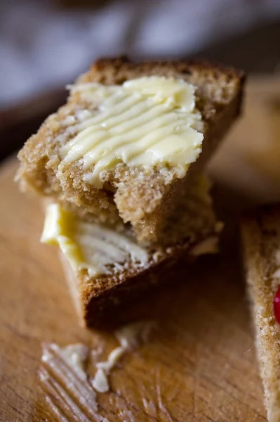 stock image Small sliced piece of wheat bread and butter