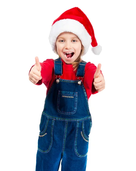 Kleines Mädchen mit Weihnachtsmütze zeigt den Daumen — Stockfoto