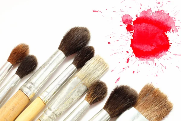 Set of brushes and red blot — Stock Photo, Image