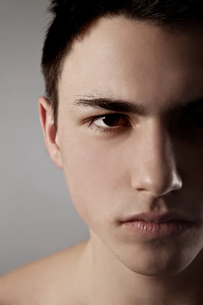 Hübsches Gesicht eines jungen Mannes in grau — Stockfoto