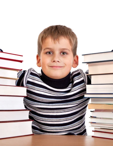 Školák a hromadu knih izolovaných na bílém pozadí — Stock fotografie