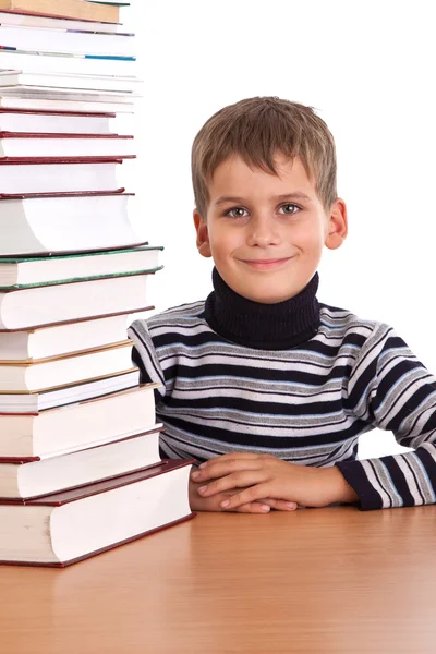 Školák a hromadu knih — Stock fotografie