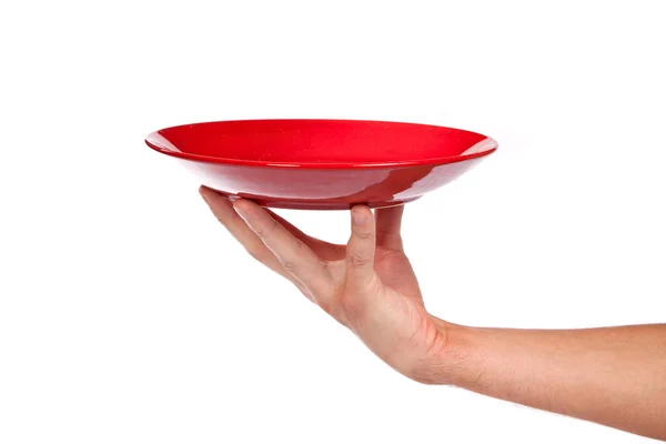 Roter Küchenteller an einer Hand isoliert — Stockfoto
