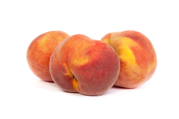 Three tasty juicy peaches on a white background — Stock Photo, Image