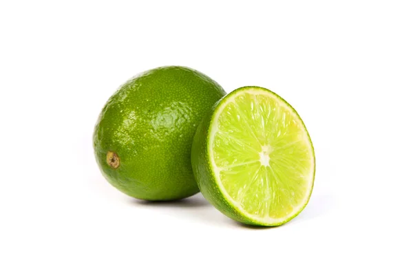 One whole lime and one half lime on white — Stock Photo, Image