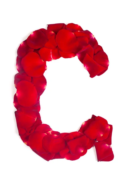 Písmeno g, které jsou vyrobené z červených okvětních lístků růže na bílém pozadí — Stock fotografie