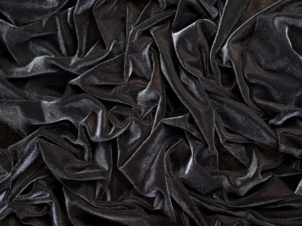 Zwarte gevouwen doek textuur achtergrond. — Stockfoto