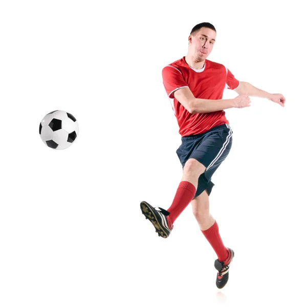 Giocatore di calcio colpisce la palla — Foto Stock