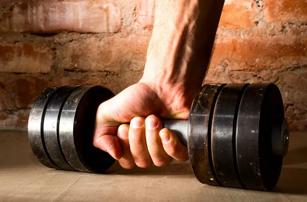Male hand is holding metal barbell — Stock Photo, Image