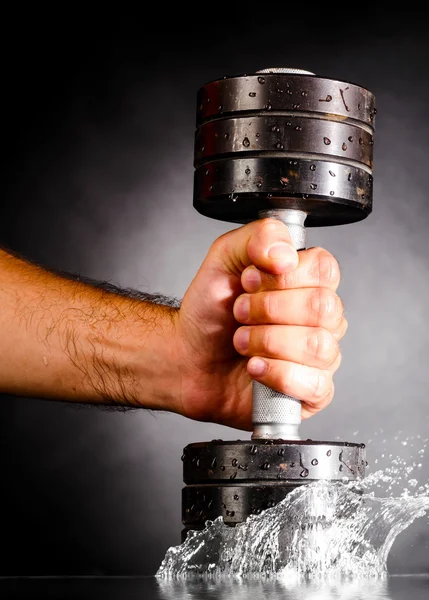 Metal barbell splashes in water — Stock Photo, Image