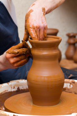 Potter makes a jug out of clay clipart