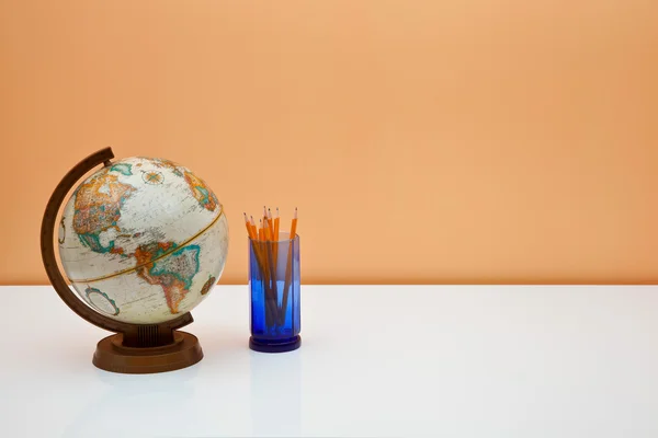 stock image Students desk with globe and pencils