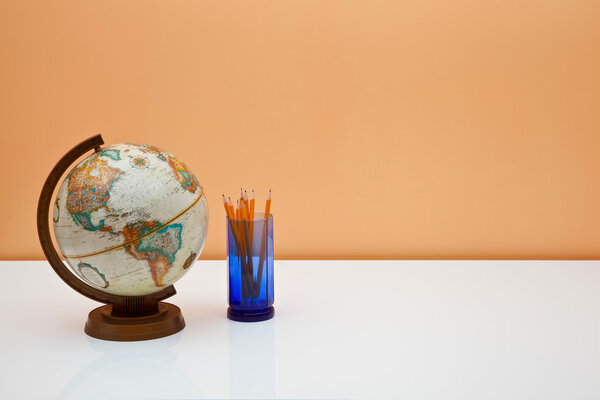 Students desk with globe and pencils