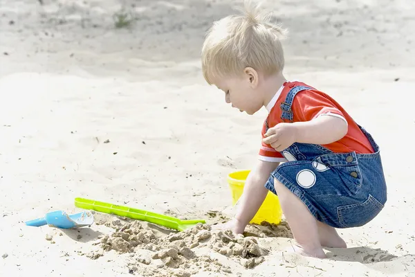 stock image A little boy plays sand