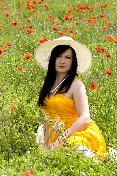 Cute brunette on the poppy field — Stock Photo, Image