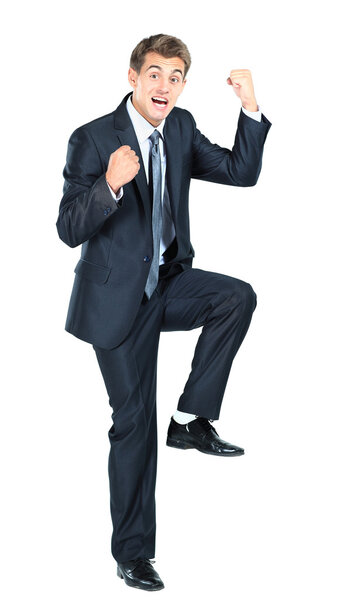 Business man throwing fists in air and smiling