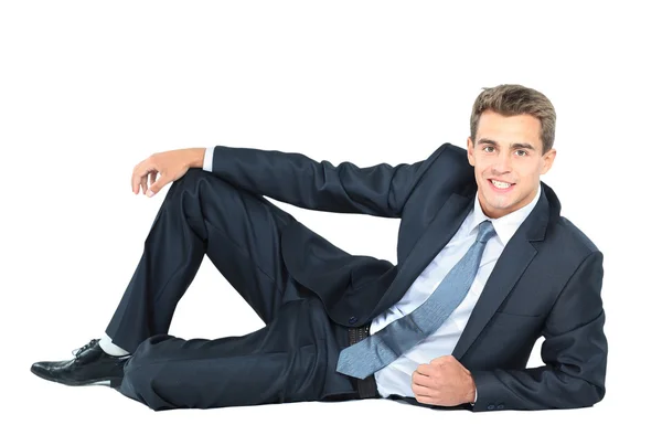 Porträtt av affärsman som sitter på golvet isolerat över vit bakgrund — Stockfoto