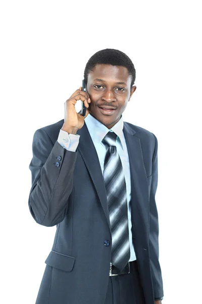 Young entrepreneur holding his coat over shoulder while talking on cell phone — Stock Photo, Image