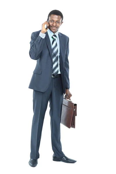 Ung entreprenör hålla rocken över axeln medan du talar i mobiltelefon — Stockfoto