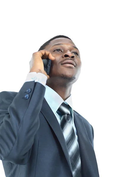 Young entrepreneur holding his coat over shoulder while talking on cell phone — Stock Photo, Image
