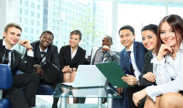 Satisfied proud business team looking at camera and smiling in office — Stock Photo, Image