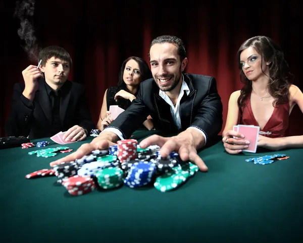 Poker player going "all in" pushing his chips forward — Stock Photo, Image