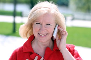 Portrait of senior lady on landline phone call clipart
