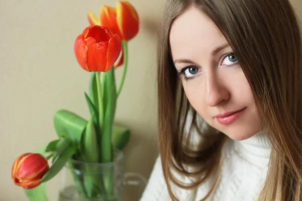 Attractive blonde holding bunch of flowers Stock Picture