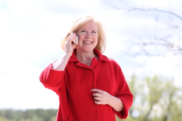 Portrait of senior lady on landline phone call — Stock Photo, Image
